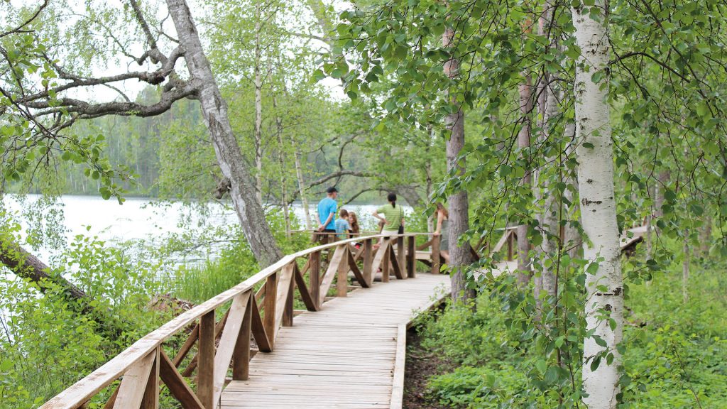 Walking across the Katiskalahti arched timber bridge